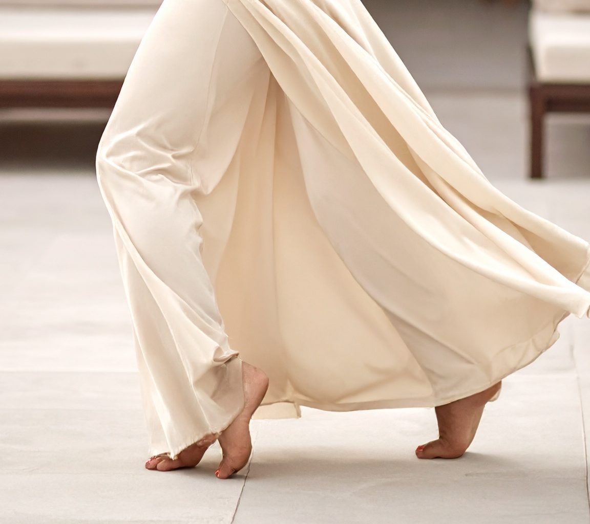 Detail: cream fabric caught mid-turn